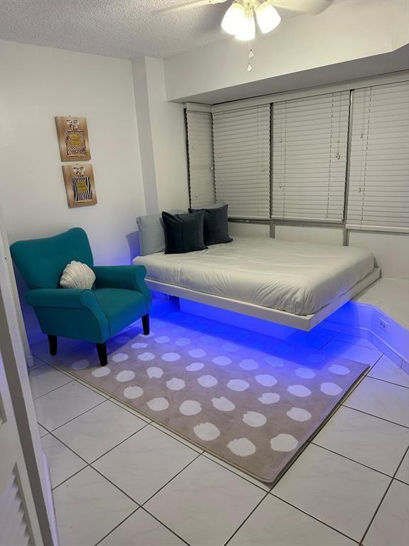 1881 Washington Avenue Miami Beach, FL 33139 - Photo 10 of 13 a bedroom with a bed and a chandelier