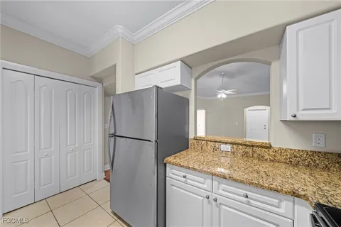 a kitchen with a refrigerator and cabinets
