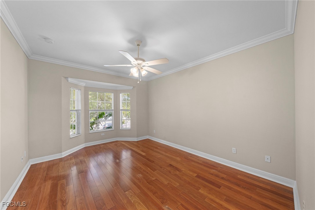 4172 Castilla Circle, Unit 201 Fort Myers, FL 33916 - Photo 10 of 34 wooden floor in an empty room with a window