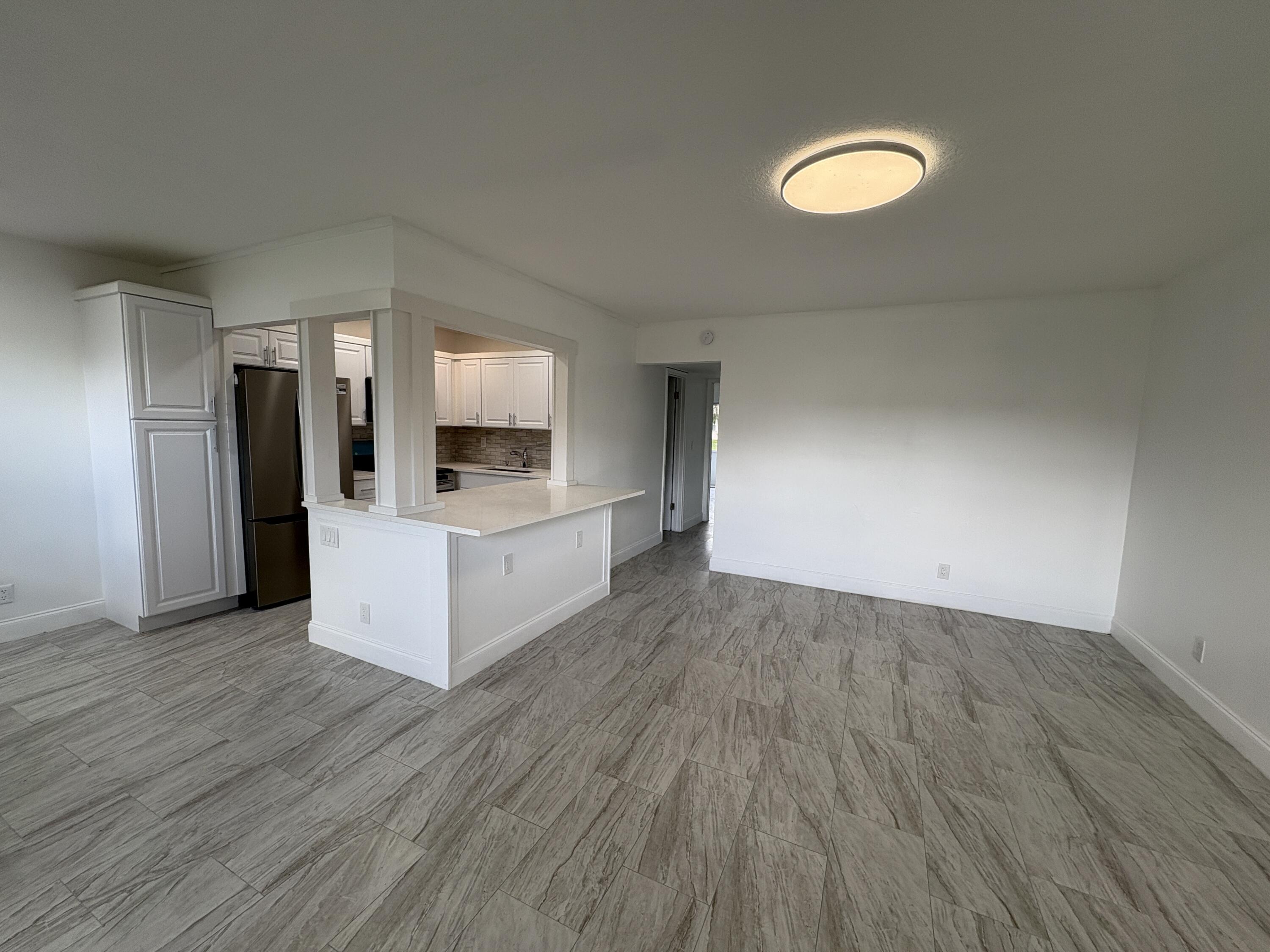 a view of a kitchen with wooden floor and a sink