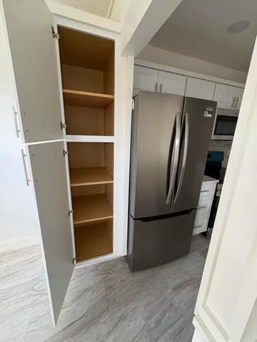 a view of walk in closet with empty racks