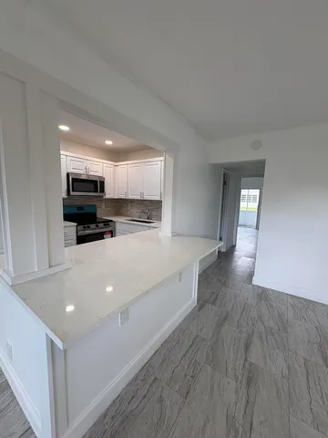 a view of kitchen with microwave and cabinets