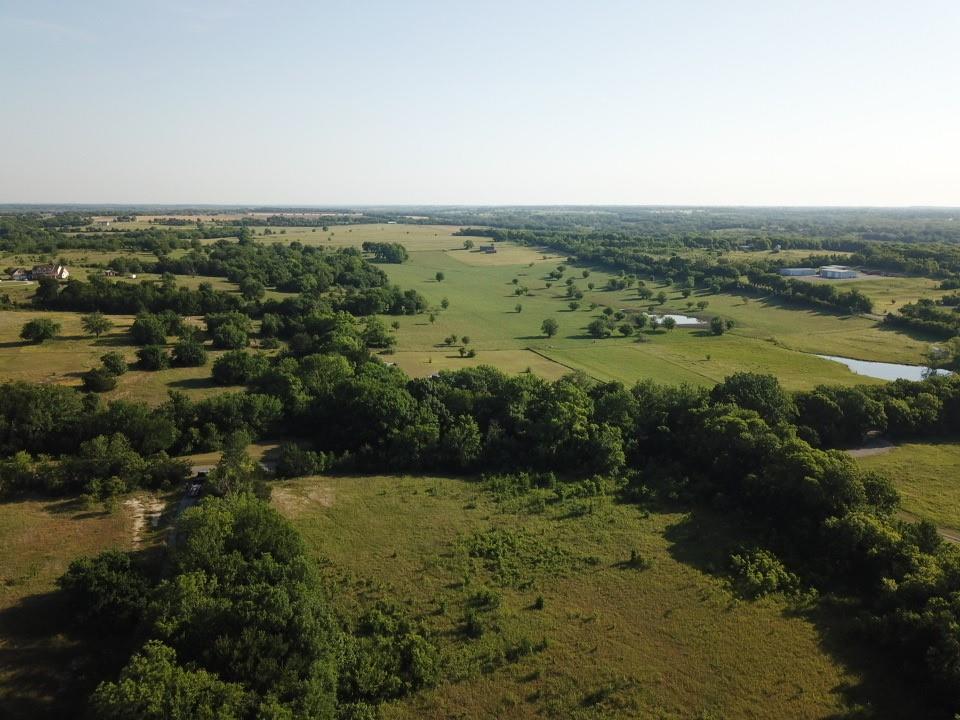 Tbd Ball Road Whitewright, TX 75491 - Photo 18 of 18 Expansive land parcels featuring open fields, scattered mature trees, and natural water features nearby.