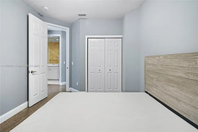 a bedroom with a bed and cabinets