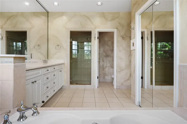 a bathroom with a shower sink and mirror
