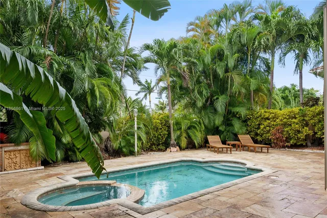 a swimming pool with trees in the background