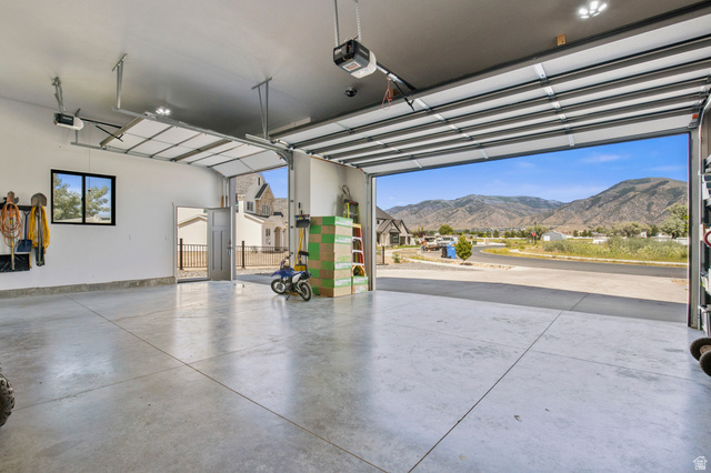 3111 South 1250 West Logan, UT 84321 - Photo 39 of 51 Spacious garage with smooth concrete flooring and overhead lighting