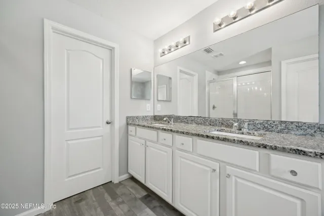 a bedroom with a bed a desk and chair