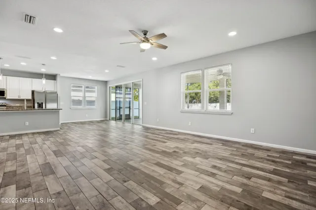 a kitchen with stainless steel appliances granite countertop a sink a stove and a wooden floors