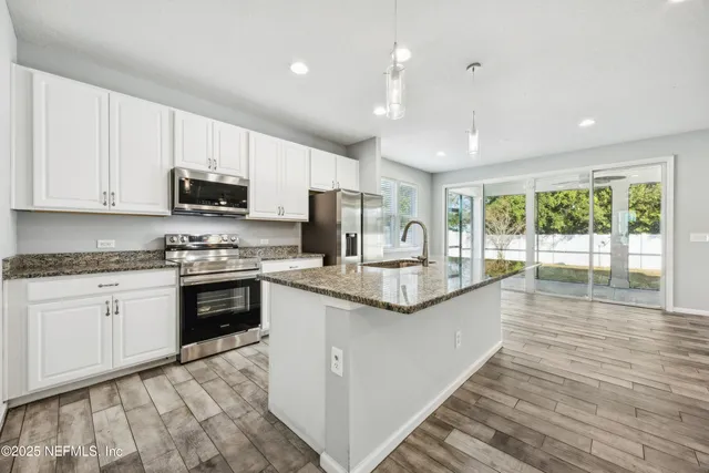 a dining room with furniture window and wooden floor