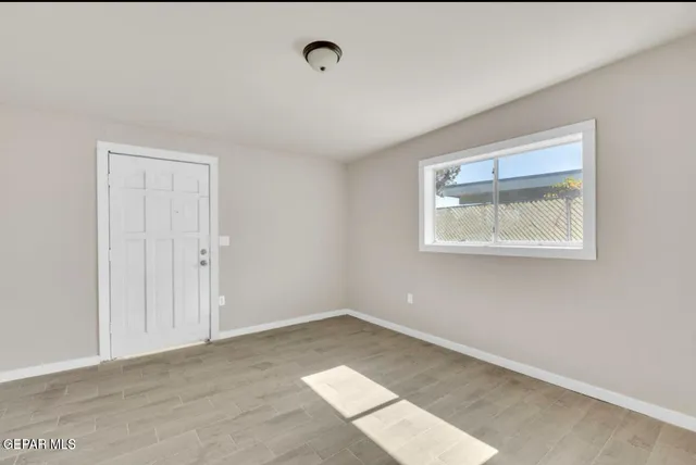 an empty room with wooden floor