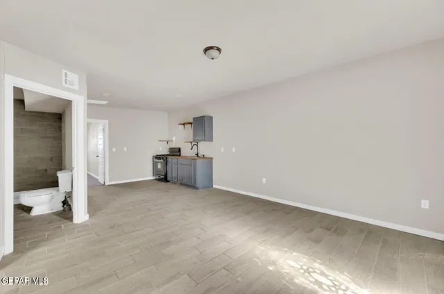 a kitchen with stainless steel appliances granite countertop a sink and stove top oven