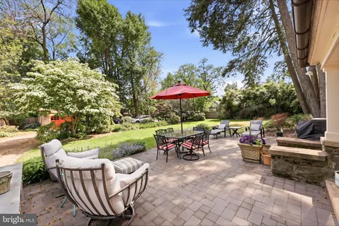 an outdoor sitting area with furniture and garden view
