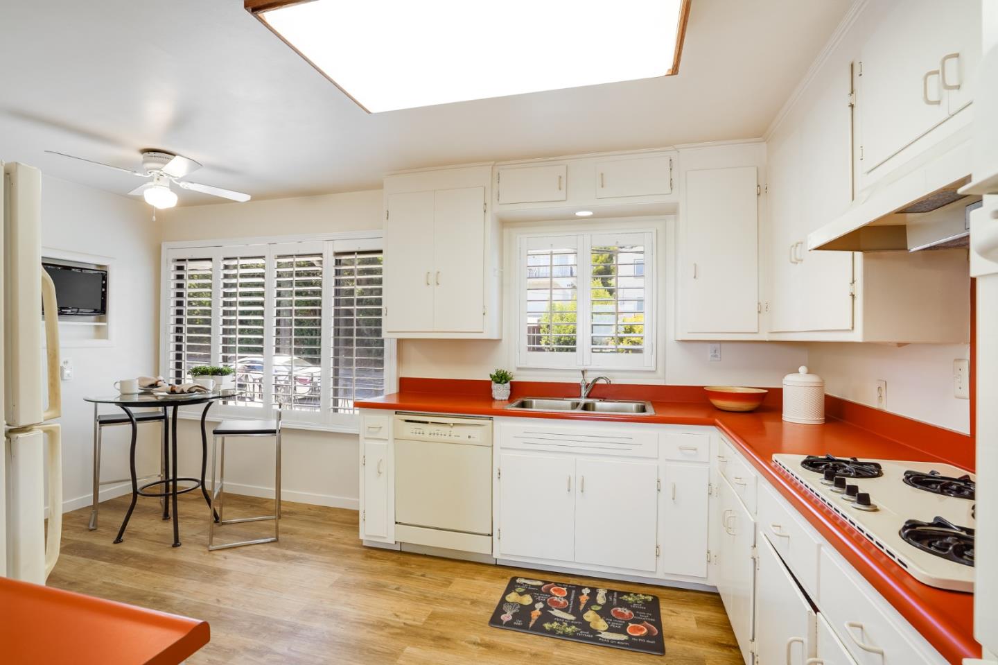 1273 Vista Grande Millbrae, CA 94030 - Photo 13 of 50 a kitchen with a sink a stove cabinets and dining table
