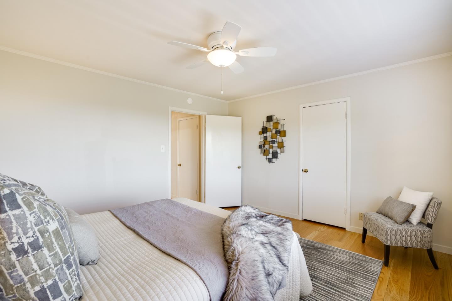 1273 Vista Grande Millbrae, CA 94030 - Photo 24 of 50 a bedroom with a bed and a chandelier