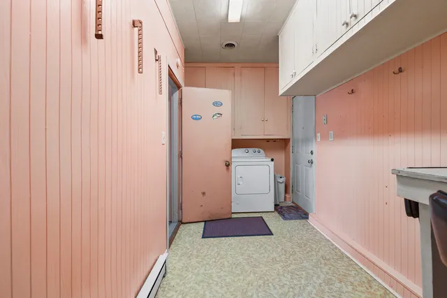 a room with furniture a air conditioner vent and a window