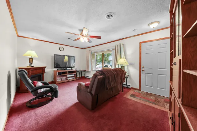 a living room with furniture a flat screen tv and a window