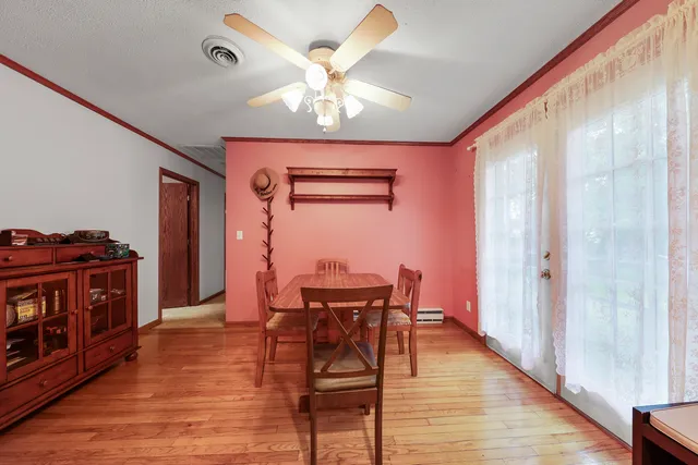 a view of a dining room with furniture and wooden floor