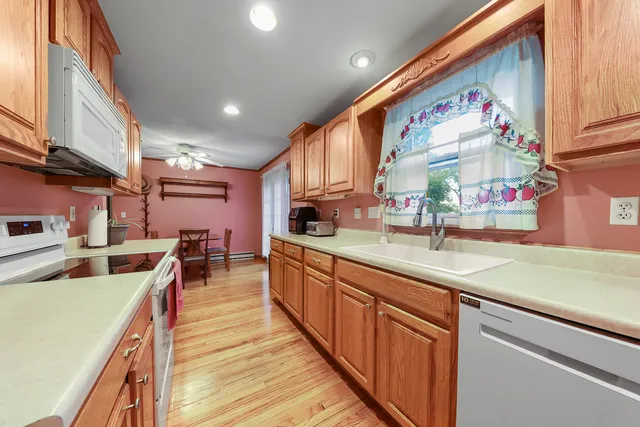 a kitchen with kitchen island granite countertop lots of counter top space and sink