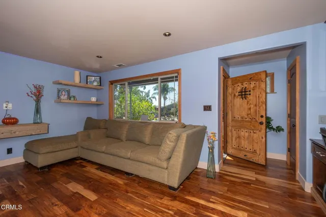 a view of a workspace with furniture and wooden floor