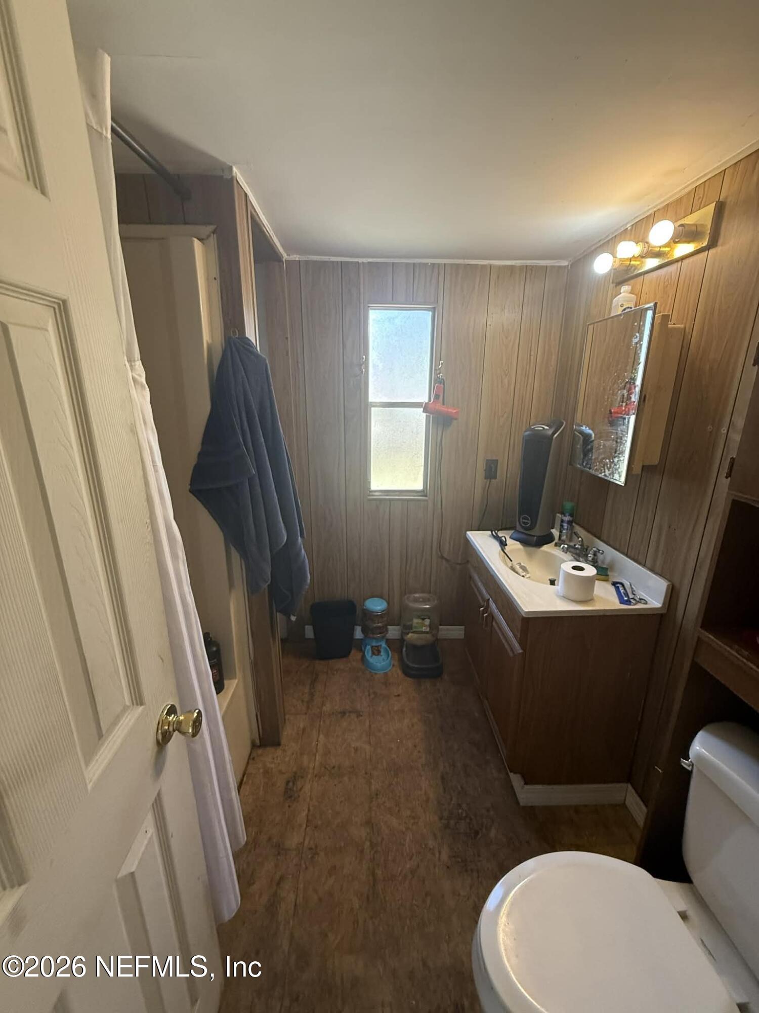6319 Bucknell Avenue Keystone Heights, FL 32656 - Photo 9 of 11 a bathroom with a sink a toilet a mirror and tub