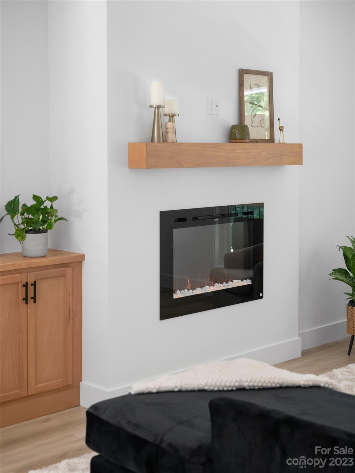 67 Raleigh Road Asheville, NC 28803 - Photo 11 of 43 a living room with a fireplace furniture and a wooden floor