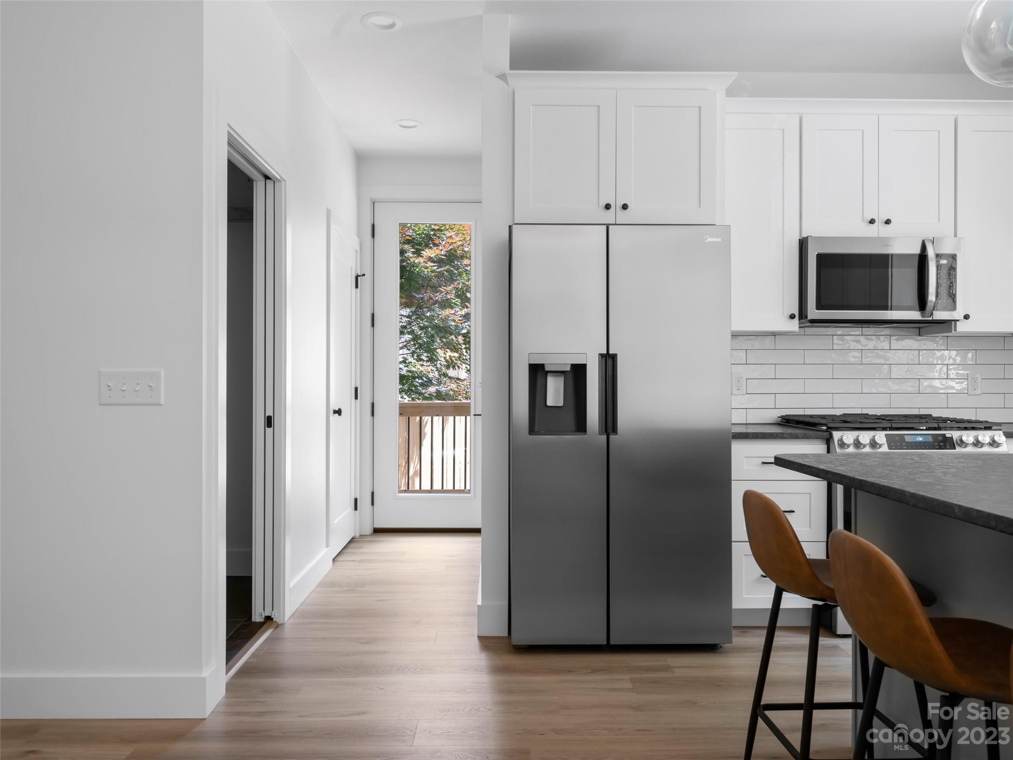67 Raleigh Road Asheville, NC 28803 - Photo 17 of 43 a kitchen with stainless steel appliances a refrigerator and a stove top oven