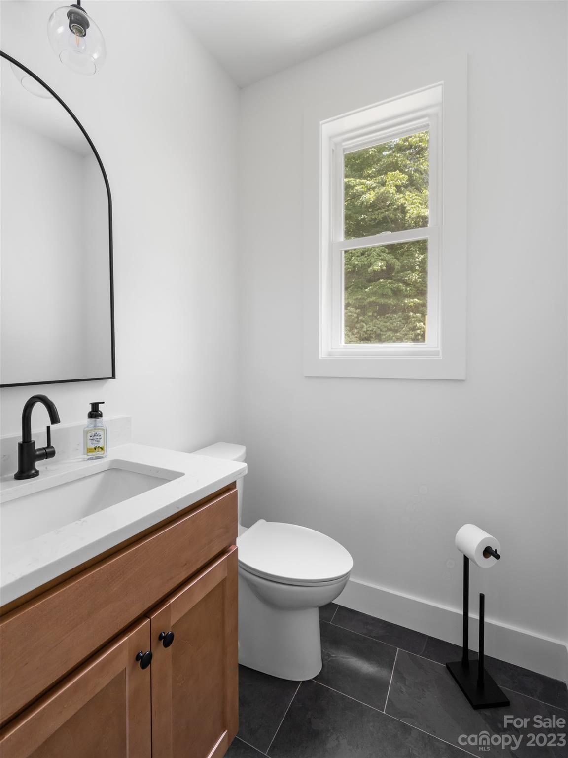 67 Raleigh Road Asheville, NC 28803 - Photo 21 of 43 a bathroom with a toilet sink and mirror