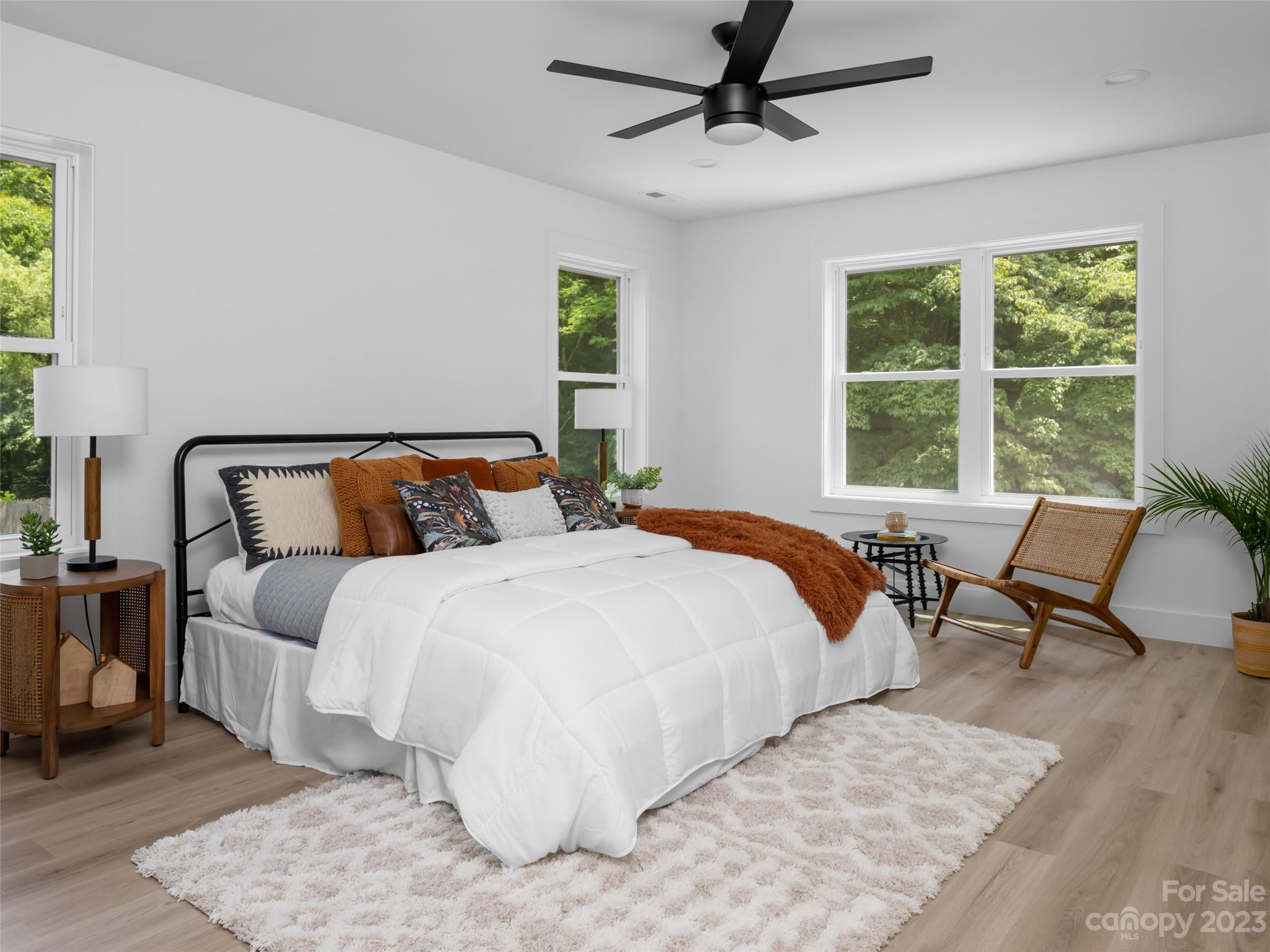 67 Raleigh Road Asheville, NC 28803 - Photo 24 of 43 a bedroom with a bed a couch and a window