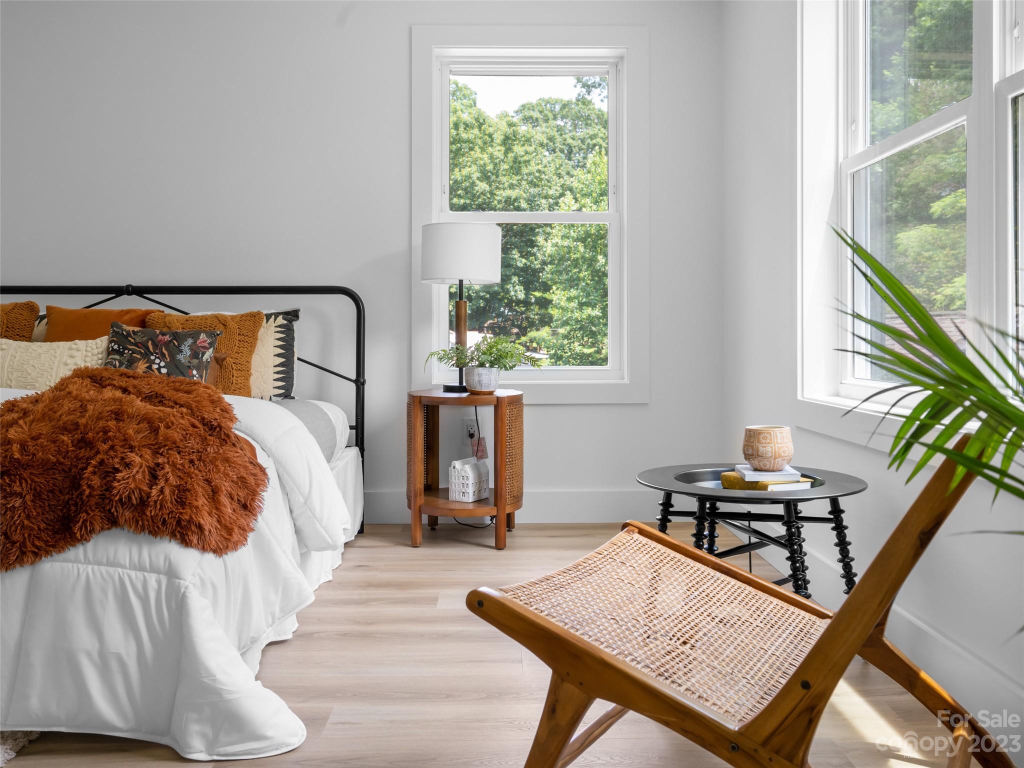 67 Raleigh Road Asheville, NC 28803 - Photo 25 of 43 a bed room with a bed window and a chair