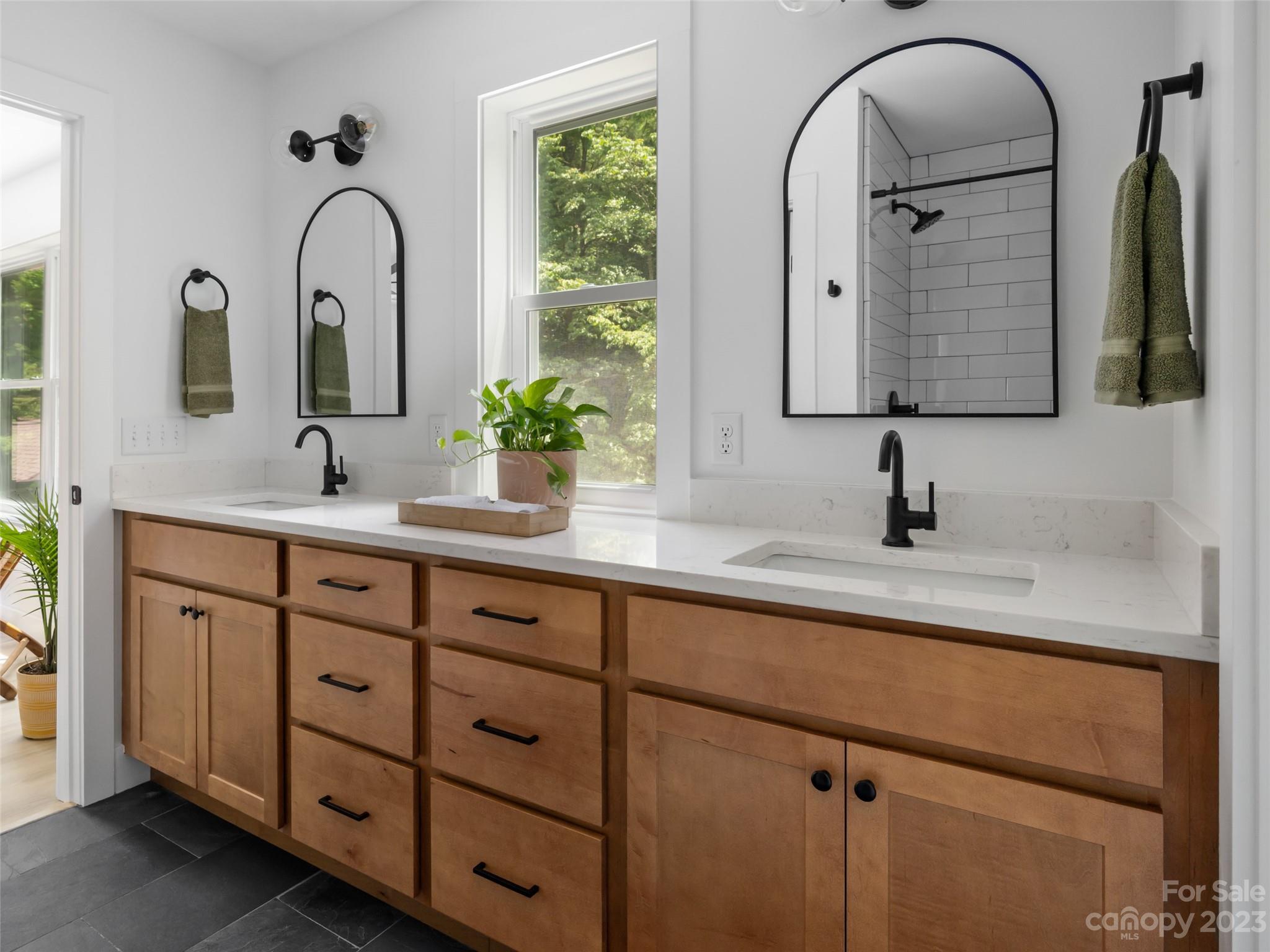 67 Raleigh Road Asheville, NC 28803 - Photo 27 of 43 a bathroom with a double vanity sink and a window