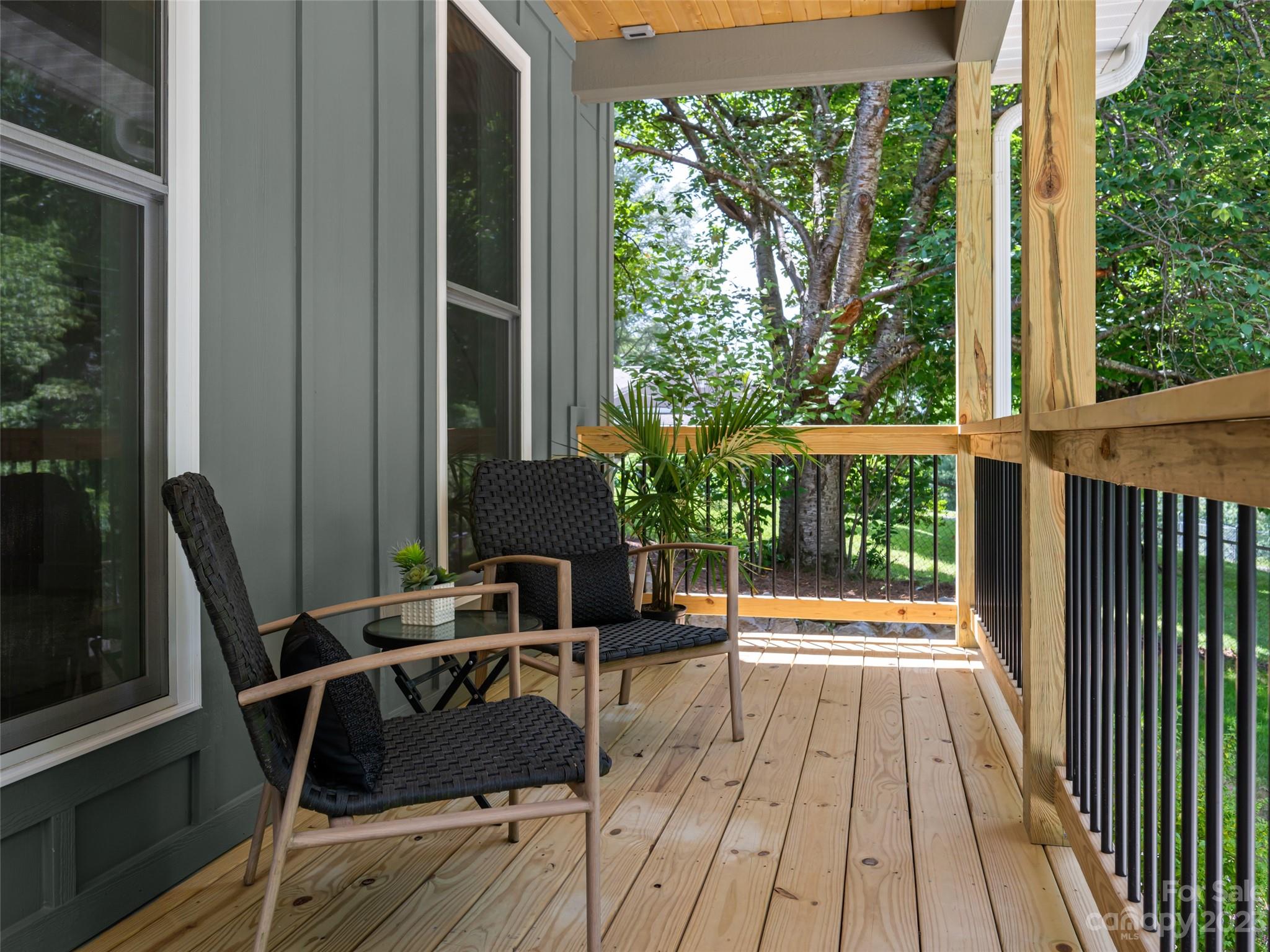 67 Raleigh Road Asheville, NC 28803 - Photo 3 of 43 a balcony with chairs and a table