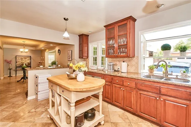 a view of a dining room with furniture a chandelier and wooden floor