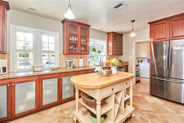 a living room with lots of furniture dining table and a chandelier