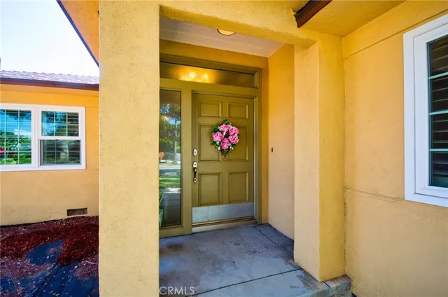 a view of a hallway with wooden floor and cabinet