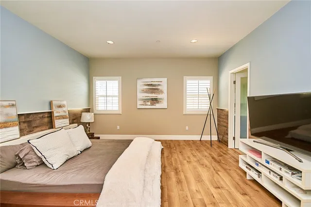 a spacious bedroom with a bed and a table in it
