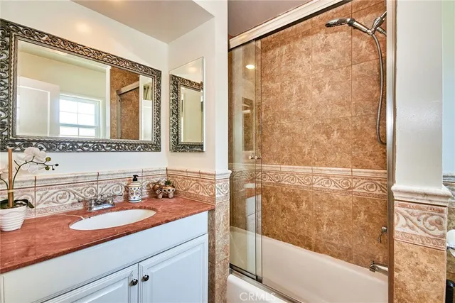 a bathroom with a glass shower door