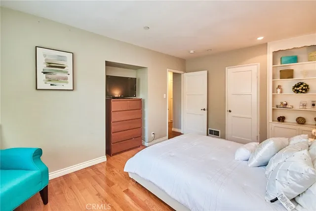 a bedroom with a bed a desk and chair