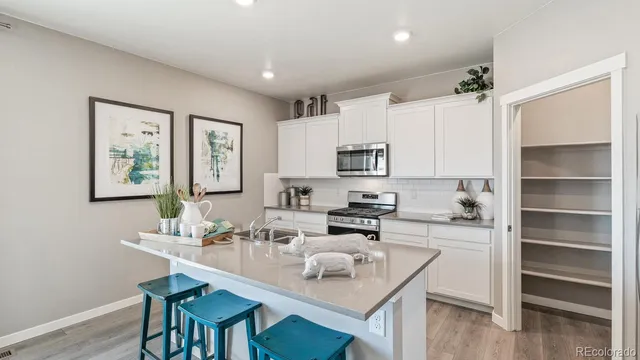 a kitchen with a sink stove and microwave