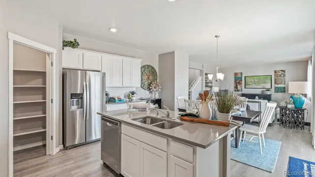 a kitchen with kitchen island a sink stove and refrigerator