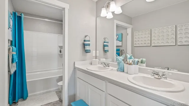 a bathroom with a double vanity sink mirror and double