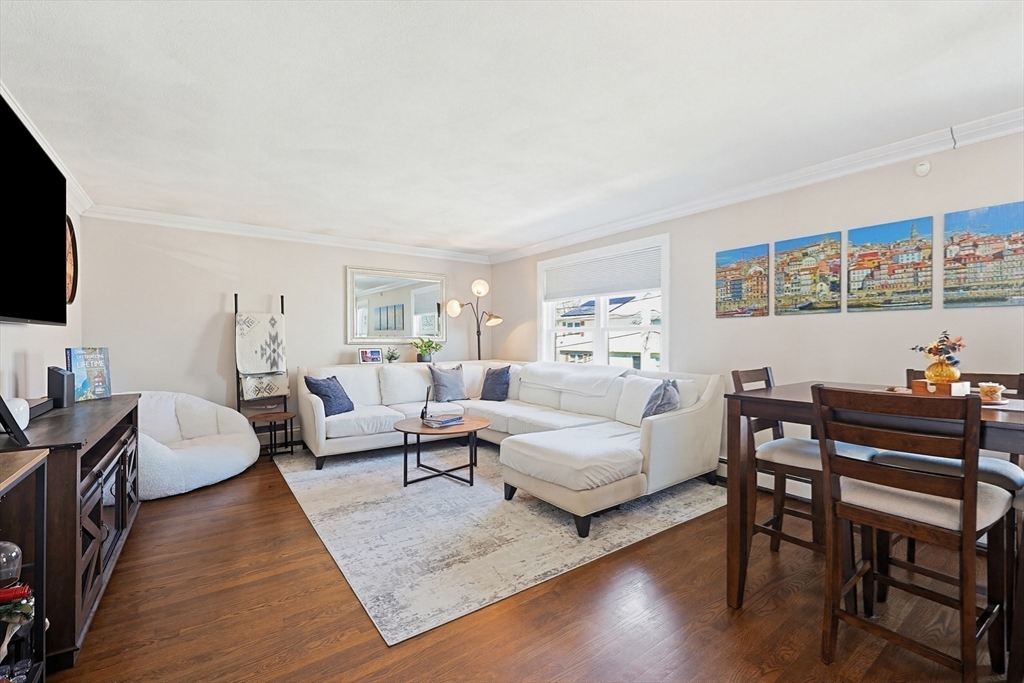 48 Calumet Street, Unit 2 Revere, MA 02151 - Photo 2 of 30 a living room with furniture wooden floor and a flat screen tv