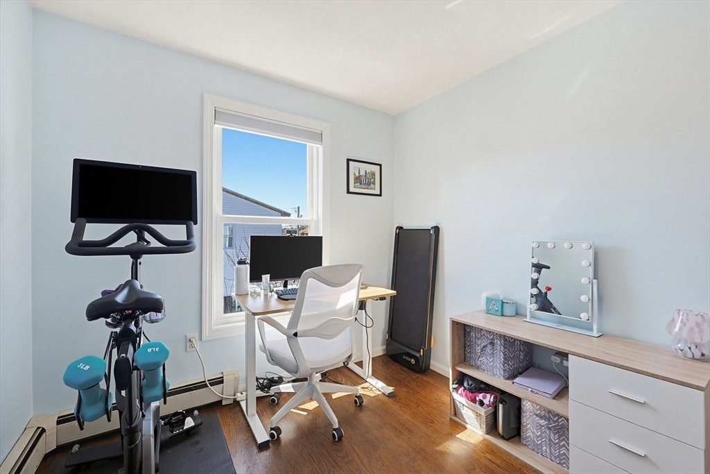 48 Calumet Street, Unit 2 Revere, MA 02151 - Photo 22 of 30 a work room with furniture and wooden floor
