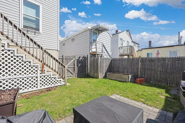 a view of a house with wooden fence and a fence