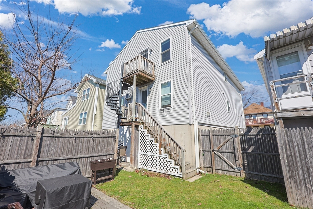 48 Calumet Street, Unit 2 Revere, MA 02151 - Photo 25 of 30 a view of a house with wooden fence and a fence