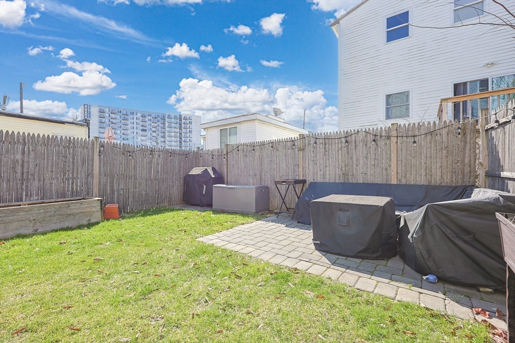 48 Calumet Street, Unit 2 Revere, MA 02151 - Photo 26 of 30 a view of a backyard with a small cabin and a chair