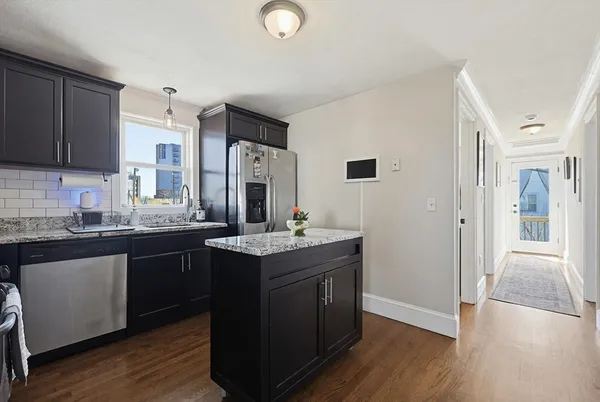 a kitchen with stainless steel appliances granite countertop a sink stove and refrigerator