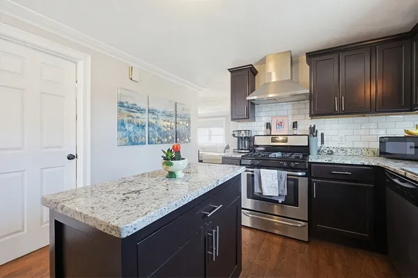 a kitchen with stainless steel appliances granite countertop a sink stove and refrigerator