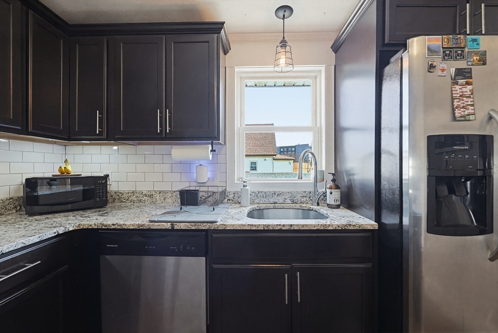 48 Calumet Street, Unit 2 Revere, MA 02151 - Photo 10 of 30 a kitchen with stainless steel appliances granite countertop a sink stove and refrigerator