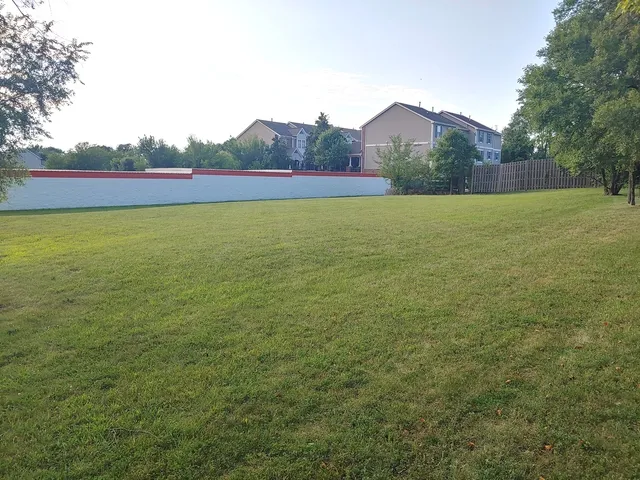 a view of a field with an ocean view